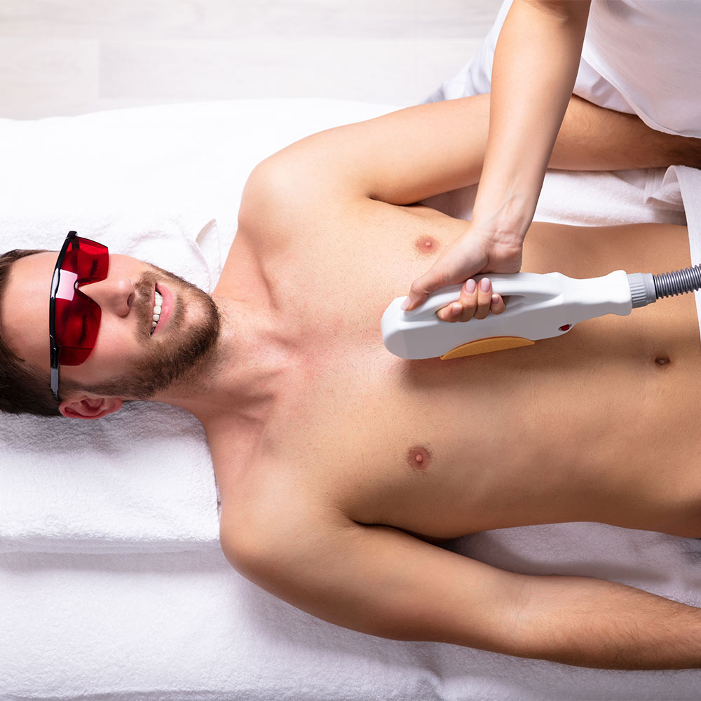 Beautician Giving Laser Epilation Treatment On Man's Chest