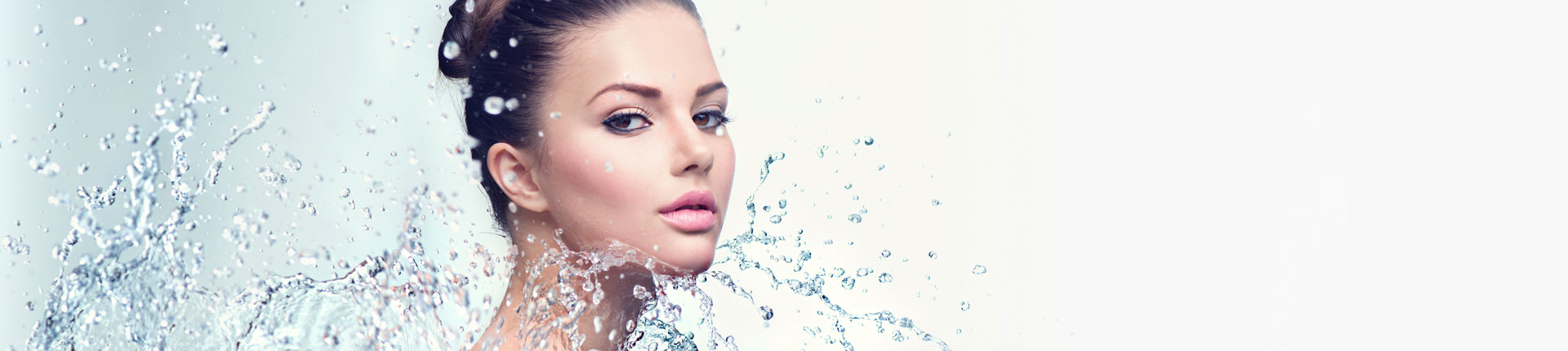 Beautiful spa woman with splashes of water